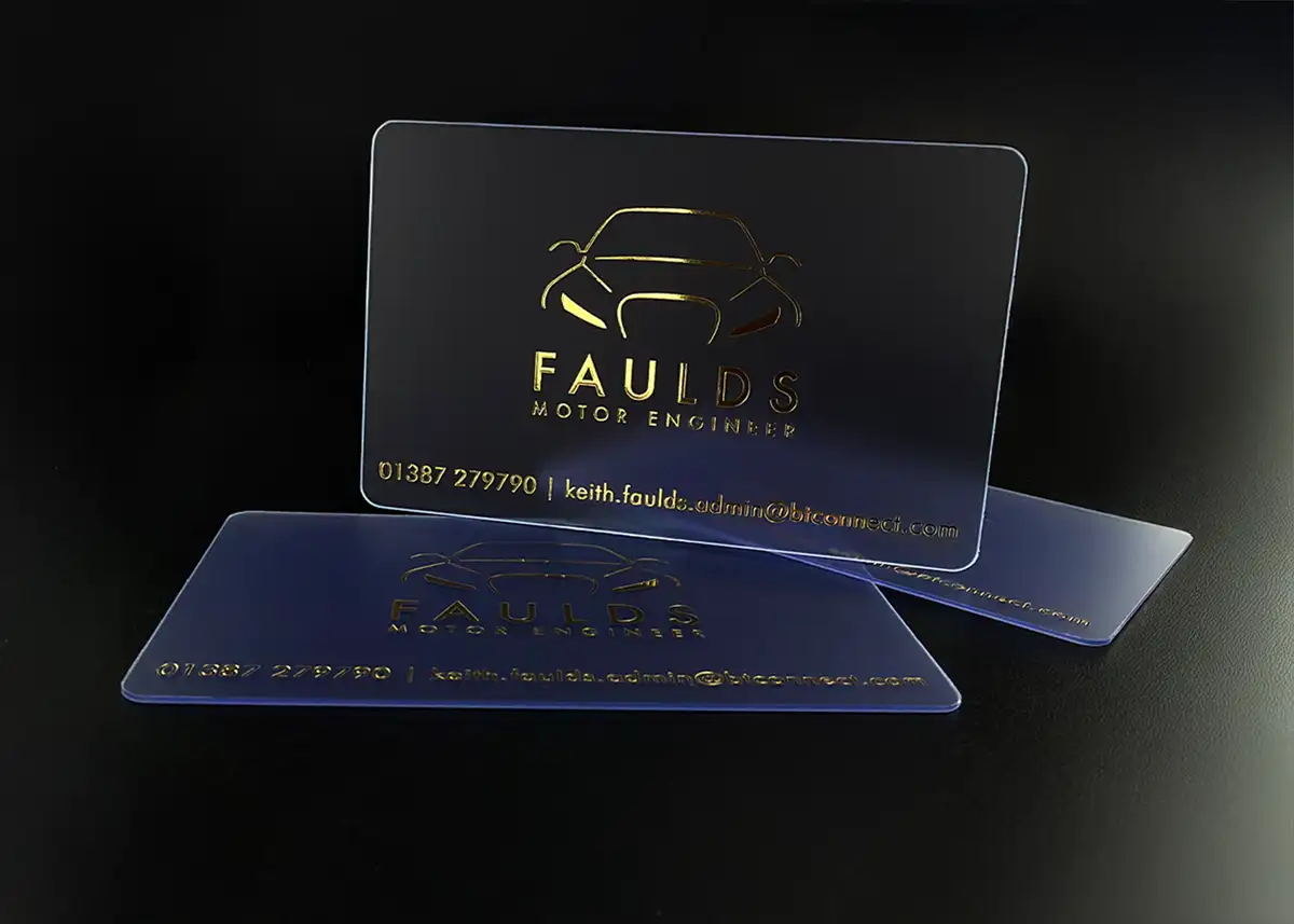 a frosted plastic card printed with metallic gold foil for the car logo