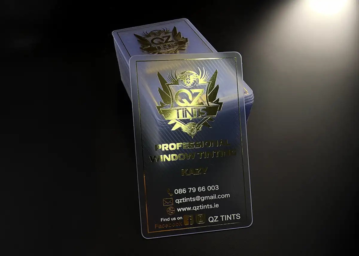 a frosted plastic card printed with metallic gold foil plus clear foil