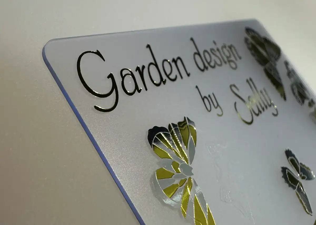 a frosted plastic card printed with metallic silver foil and metallic gold foil
