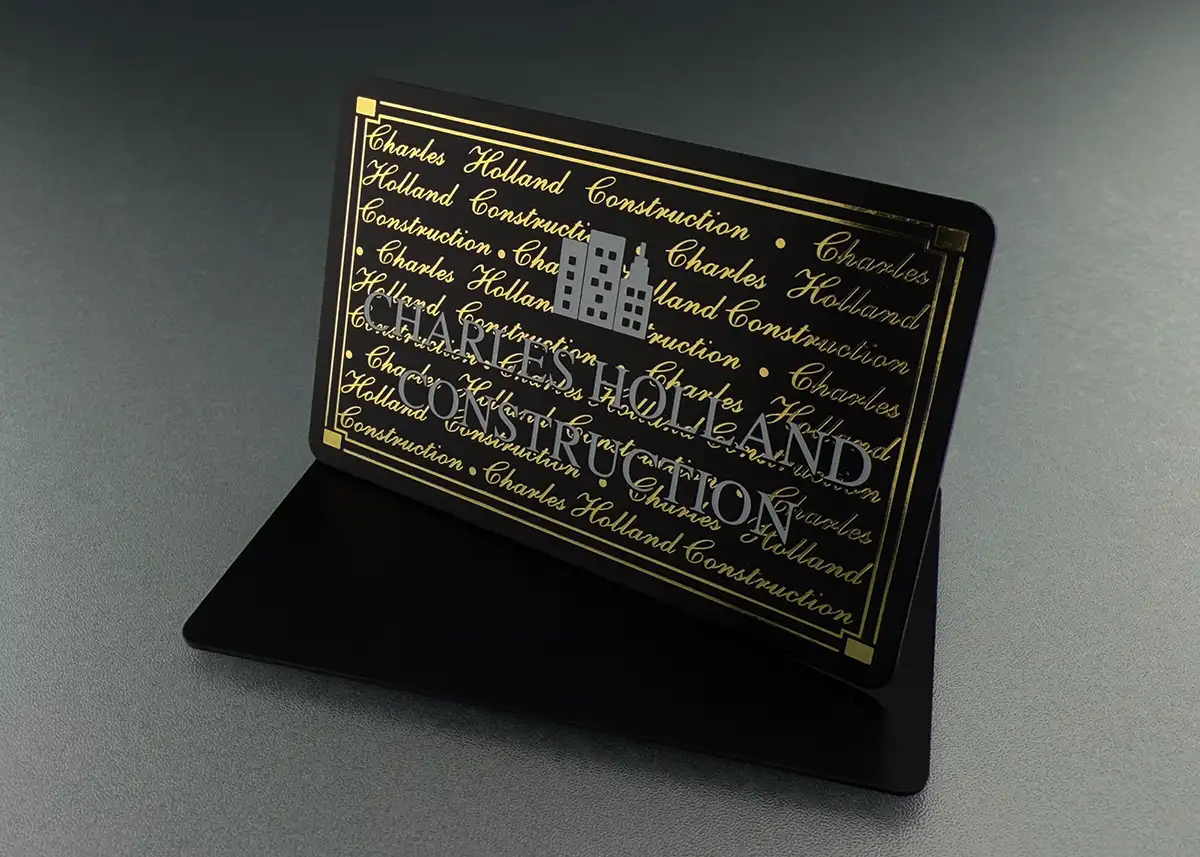 a satin black plastic card printed with holoprint plus white ink including an intricate logo