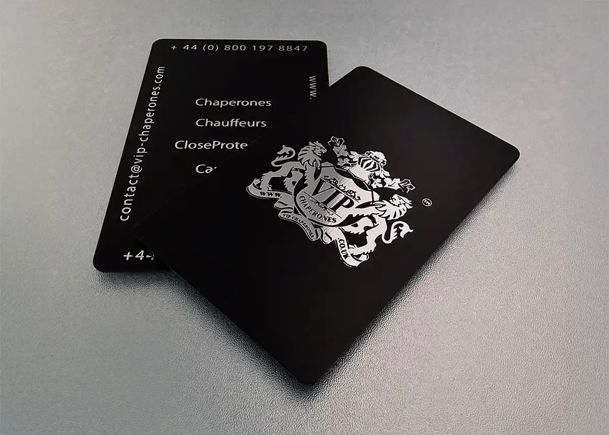 a satin black plastic card printed with metallic silver foil on each side