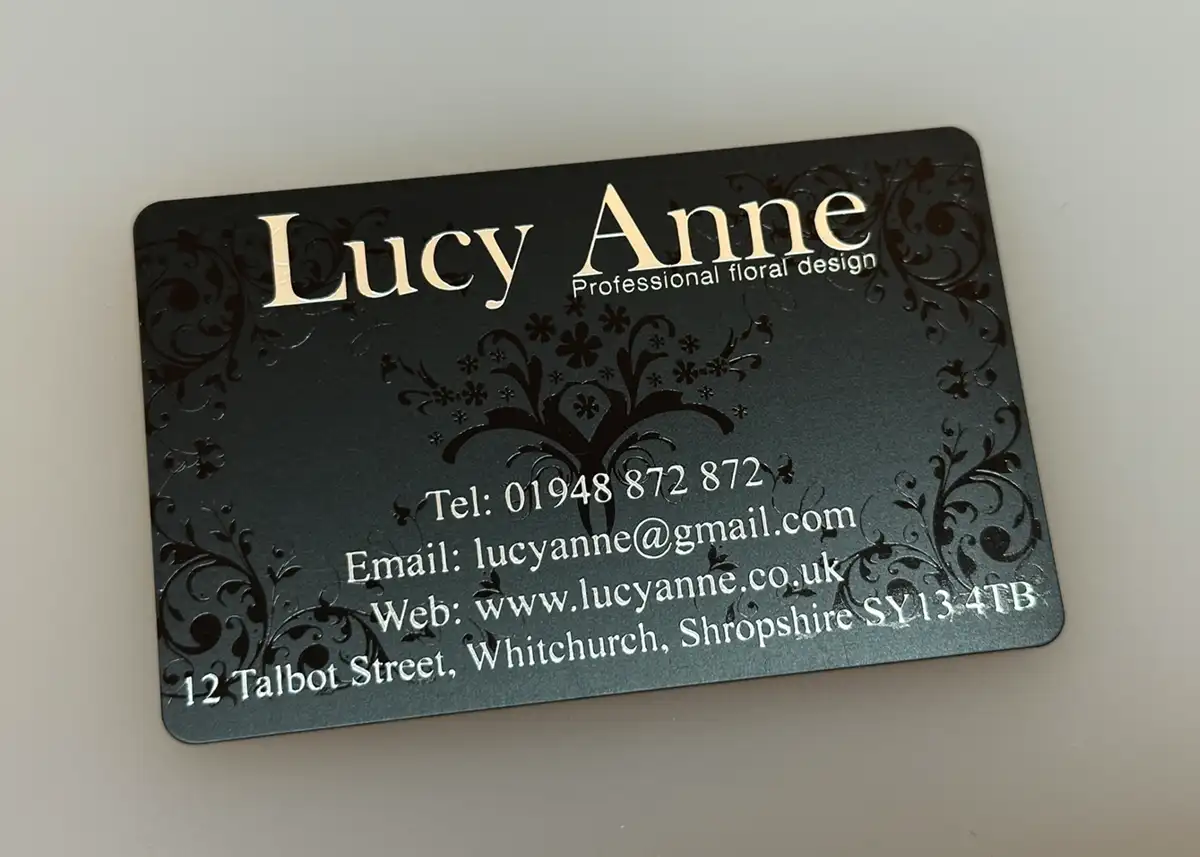 a satin black plastic card printed with metallic silver plus gloss black ink