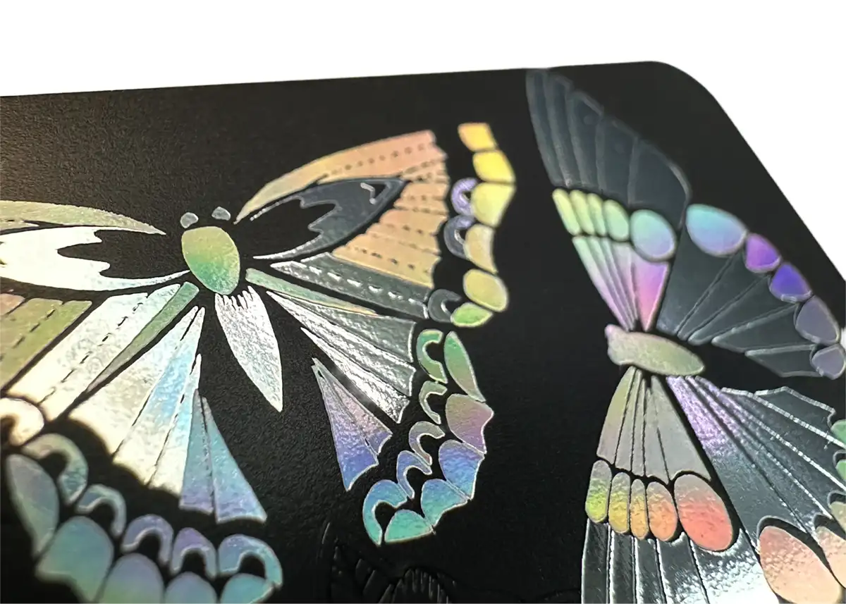 a satin black plastic card printed butterflies in holoprint and metallic silver foil
