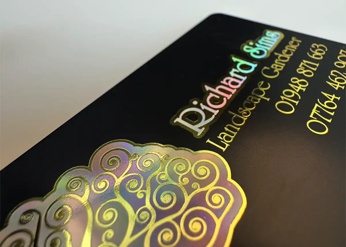 a satin black plastic card printed with holoprint plus metallic gold foil